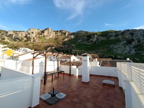 a view from the balcony of a house with a mountain at Amapola Alojamiento Rural in Zuheros