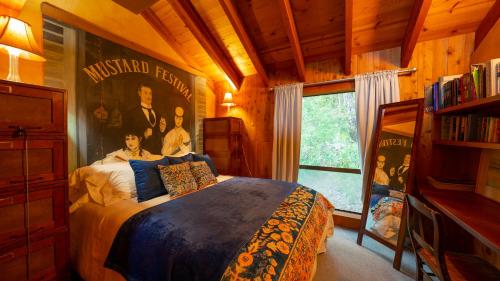 a bedroom with a bed with a poster on the wall at Inn Wine Country - Summers House in Sonoma