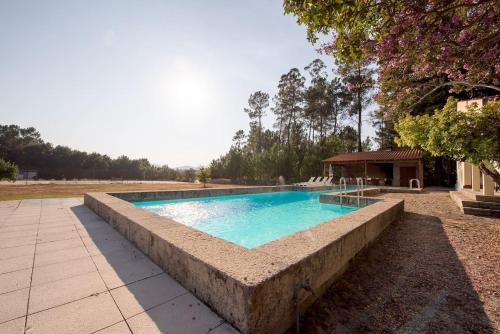 uma piscina com uma parede de pedra à volta em 5 bedrooms chalet with private pool and wifi at Sao Pedro do Sul em São Pedro do Sul
