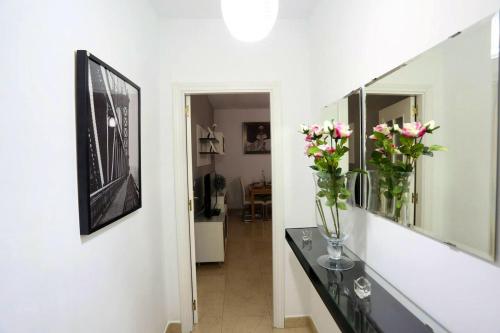 a hallway with a vase of flowers on a table at 2 bedrooms appartement with wifi at Arcos de la Frontera in Arcos de la Frontera