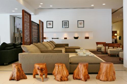 a living room with a couch and tree stump furniture at Napa Mermaid Hotel & Suites in Ayia Napa
