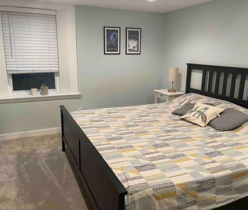 a bedroom with a large bed in a room at Sweet Beech St Retreat-Basement Apt in Portland
