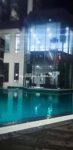 a swimming pool in front of a building at My Dallyne's Homestay at The Heights Residence, Ayer Keroh, Melaka in Ayer Keroh