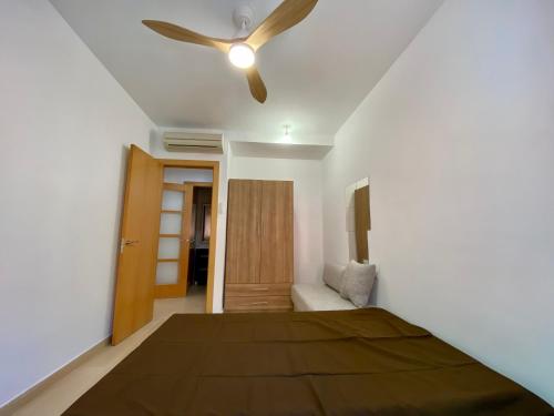 a bedroom with a bed and a ceiling fan at Estancias mensuales Terrassa in Terrassa