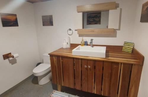 a bathroom with a sink and a toilet at Rancho Almendras at Hacienda Nosara in Nosara