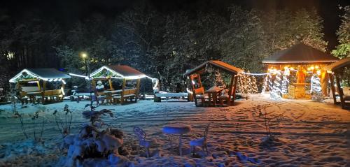 a group of gazebos in the snow at night at Pensiunea Agroturistica Cerna, Vaideeni - Polovragi in Vaideeni