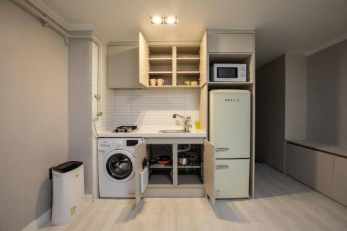 a kitchen with a sink and a washing machine at Special House in Seoul