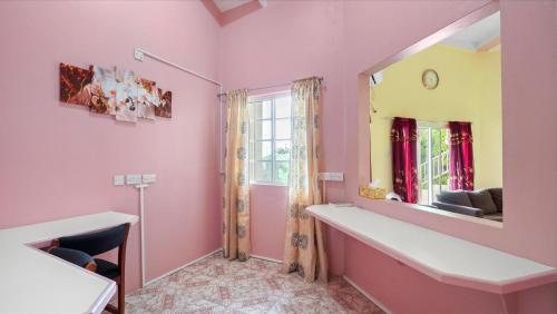 a pink room with a mirror and a sink at Your roomy comfortable place K4 in Morne Rouge