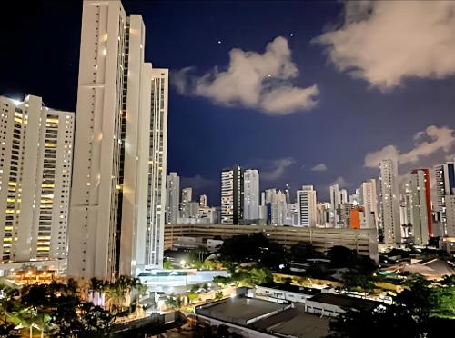 a city skyline at night with tall buildings at FLAT Boa Viagem - 50m da Praia - Garagem GRÁTIS - 24H CHECK IN - in Recife