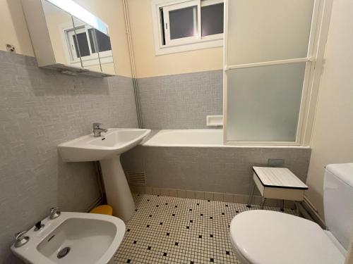 a bathroom with a sink and a tub and a toilet at Studio Les Sables-d'Olonne, 1 pièce, 2 personnes - FR-1-197-265 in Les Sables-d'Olonne
