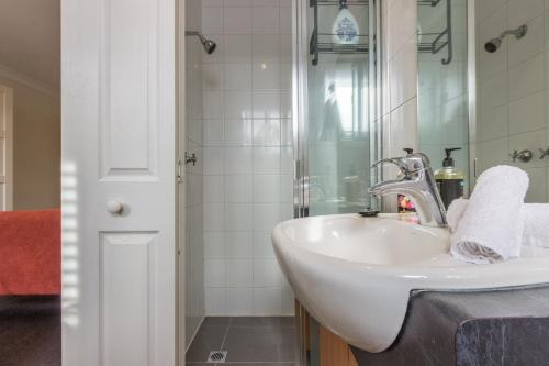 a bathroom with a sink and a shower at Studio Apartment in the heart of Fitzroy in Melbourne