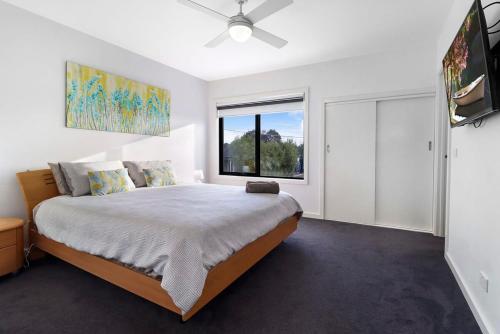 a bedroom with a large bed and a window at Raven West House I Corporate or Holiday in Geelong West