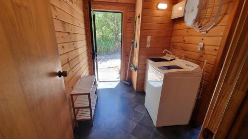 a bathroom with a washer and dryer in a house at 19 Torquay Terrace in Hanmer Springs