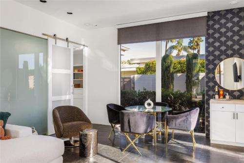 a living room with a table and chairs at Private Pool & Mountain Views! in Palm Springs