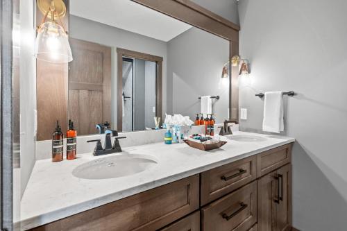 a bathroom with two sinks and a large mirror at The Belle Retreat in Center City