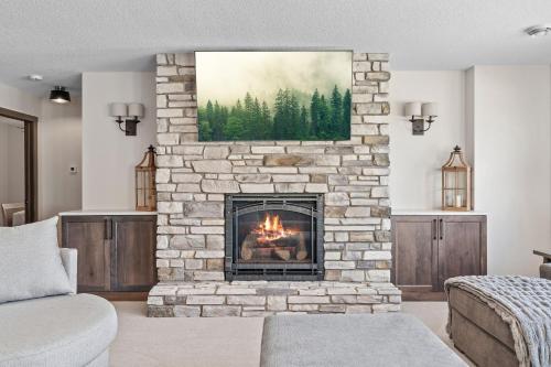 a living room with a stone fireplace with a painting at The Belle Retreat in Center City