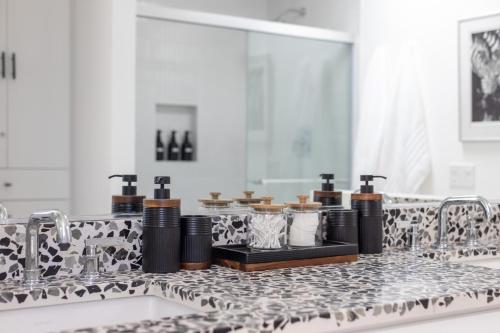 a bathroom counter with a sink and a mirror at Private Pool & Mountain Views! in Palm Springs