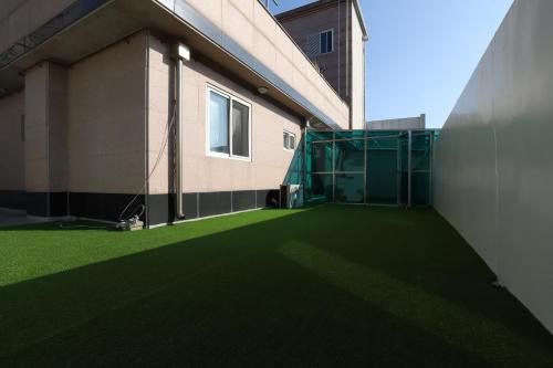 a building with a green artificial grass at Z Hotel in Cheongju