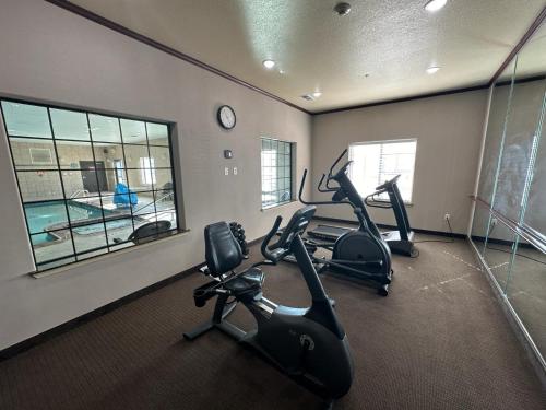 a gym with treadmills and ellipticals in a room at Sleep Inn & Suites at Six Flags in San Antonio