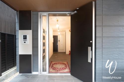 an open door to a hallway with a rug at WeeklyHouse Silto Crete - Vacation STAY 61955v in Otsu