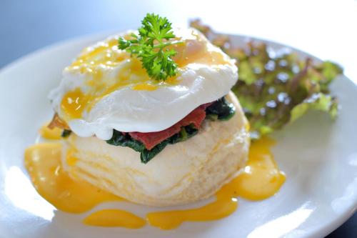 a plate of food with an egg on top at Lotus Tirta Seminyak in Seminyak