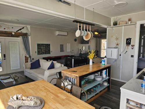 a living room with a couch and a table at Hidden Gem Guest House in Panama City Beach