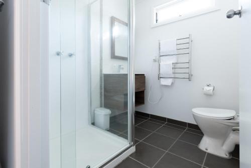 a bathroom with a shower and a toilet at Thrower Cottage: Gateway to the Cataract Gorge in Royal Park