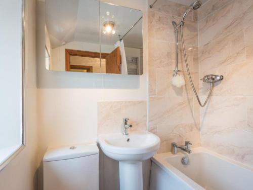 a bathroom with a sink and a toilet and a mirror at 3 Bed in Gosforth SZ064 in Gosforth