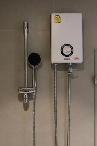 a machine on the wall of a bathroom at C'HOUSE Bangkok in Pom Prap