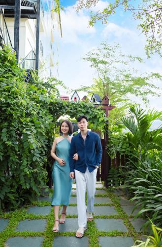 a man and a woman standing on a walkway at Shining Riverside Hoi An Boutique & Spa in Hoi An