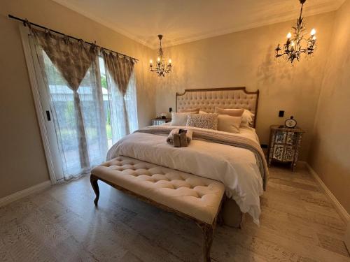 a bedroom with a large bed with a large window at Collins Cottage - Luxury Accommodation in Bright