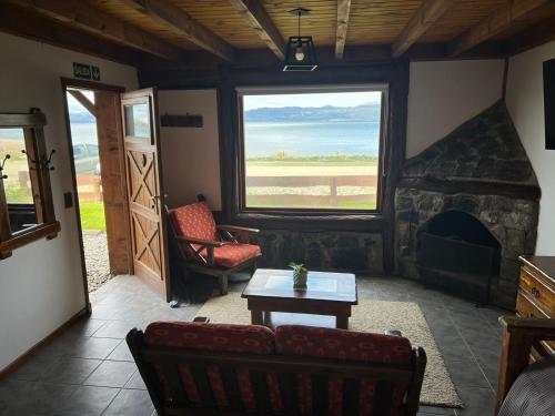 a living room with a couch and a fireplace at COSTA DE LOS PAJAROS in Ushuaia