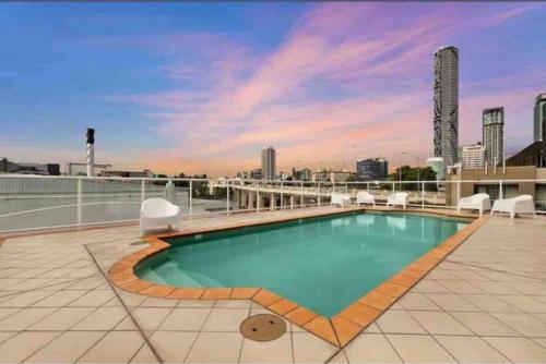 a swimming pool on the roof of a building at South Brisbane modern apartment in Brisbane