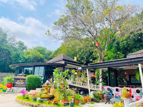 a house with a lot of plants in front of it at สงขลาคีรี รีสอร์ท SongkhlaKeeree Resort in Ban Khao Rup Chang
