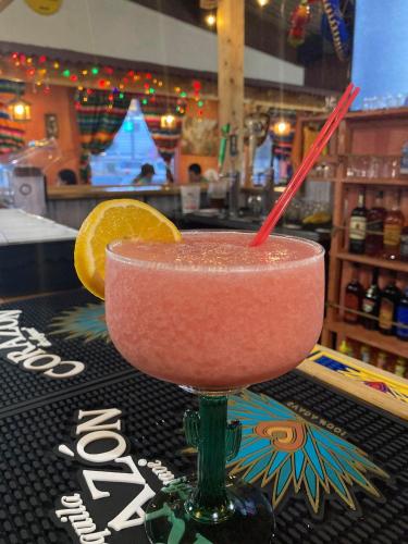 a drink in a martini glass on a table at Casa Lemus Inn in Raton