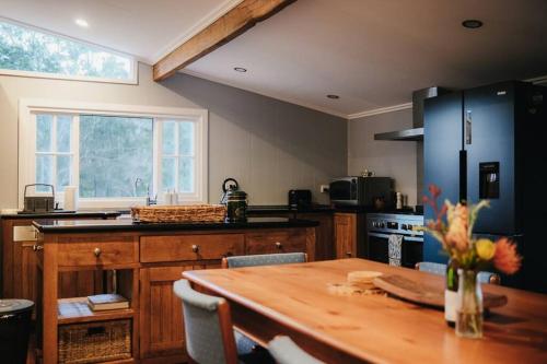 a kitchen with a wooden table and a kitchen with a tableablish at Gheerulla Place in Gheerulla