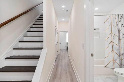 a hallway with stairs and a toilet in a house at Luxurious & Spacious 3Bed/3Bath with Outdoor Patio in Philadelphia