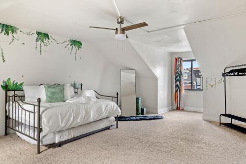 a bedroom with a bed and a ceiling fan at Contemporary loft 5-min to downtown in Pittsburgh