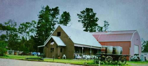 a barn with a wagon in front of it at Mountview Wines and Accommodation in Glen Aplin