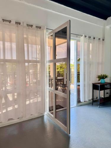 a sliding glass door in a room with a table at Canto Tièro Suite Room in Mabini