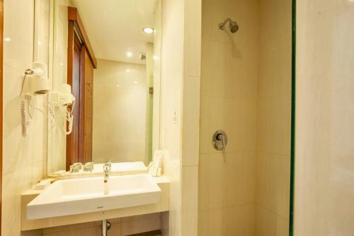 a bathroom with a sink and a shower at Amani Suite and Apartment ZN41 in Senggigi