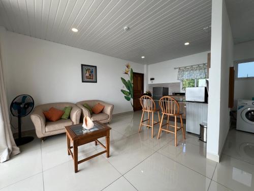 a living room with a couch and a table at Creole Pearl Self-Catering in Victoria
