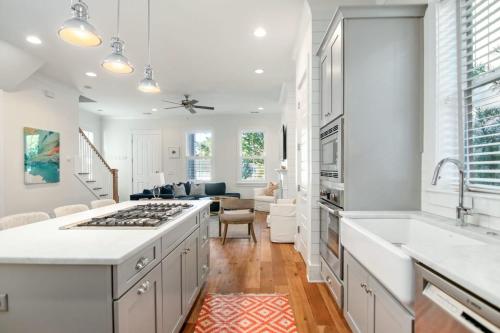 a kitchen with white cabinets and a stove top oven at Shem Creek House- 5 Mins to Downtown & Beach in Charleston