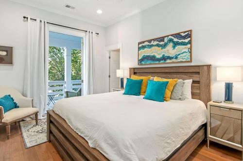 a bedroom with a large bed and a chair at Shem Creek House- 5 Mins to Downtown & Beach in Charleston