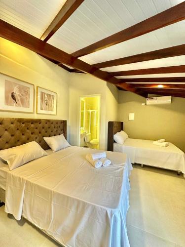 Ένα ή περισσότερα κρεβάτια σε δωμάτιο στο Pousada Casa Canoa - Pé na Areia & Alta Gastronomia