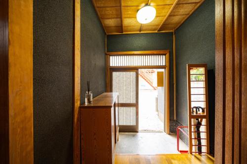 a room with a hallway with a door and a table at Kamekawa Yukari Ann in Beppu
