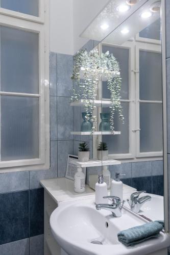 a bathroom with a sink and a mirror at Harmony & Cute - central apartments in Budapest