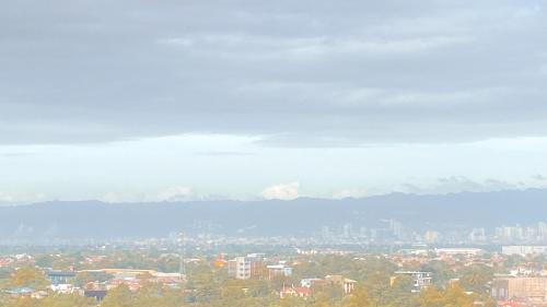 a view of a city with mountains in the background at Sea & City lights View in Lapu Lapu City