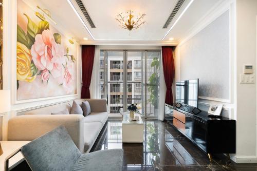 a living room with a couch and a tv at Scenic valley Serviced Apartment in Ho Chi Minh City