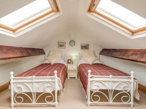 two beds in a attic bedroom with skylights at 3 bed in Ullock SZ043 in Arlecdon